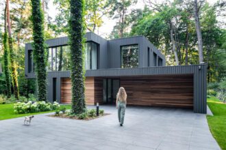 house merged into the forest poland