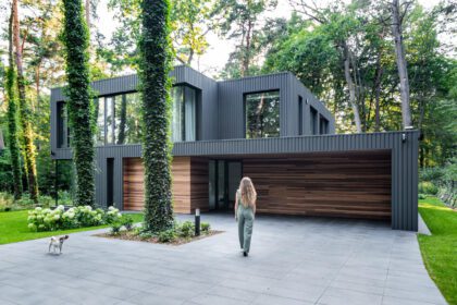 house merged into the forest poland